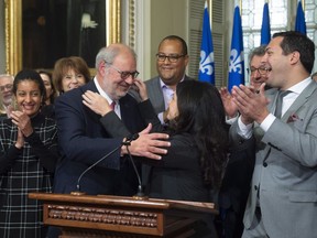 Interim Quebec Liberal Opposition Leader Pierre Arcand, centre left, is congratulated by Liberal caucus president Filomena Rotiroti, centre right, while caucus members applaud, Friday, October 5, 2018 at the legislature in Quebec City. Arcand was chosen by the caucus to lead the opposition.