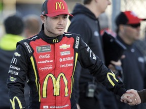 NASCAR Cup Series driver Kyle Larson shakes hands with a fan before qualifying for this weekend's auto race at Kansas Speedway in Kansas City, Kan., Friday, Oct. 19, 2018. Larson lost his appeal of a rules violation from last week's race.