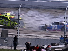 Austin Cendric (22) is sent airborne by Ryan Reed (16) as Spencer Gallagher (23) tries to avoid the wreck during the NASCAR Xfinity Series auto race at Kansas Speedway in Kansas City, Kan., Saturday, Oct. 20, 2018.