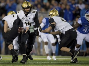 Vanderbilt quarterback Kyle Shurmur (14) hands the ball off to tight end Cody Markel (45) during an NCAA college football game against Kentucky in Lexington, Ky., Saturday, Oct. 20, 2018.