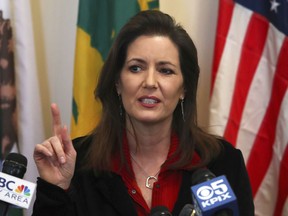 FILE - In this March 7, 2018, file photo, Oakland Mayor Libby Schaaf gestures during a news conference in Oakland, Calif. Schaaf says she has ordered an end to a police department's policy that forced job applicants to give it access to confidential records, including those that would disclose if they had been sexually assaulted. Schaaf said in a statement Sunday, Oct. 21, 2018, she has also ordered a thorough review of the Oakland Police Department's hiring practices.