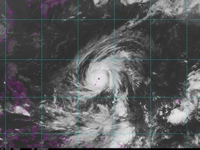 This satellite image provided by the National Oceanic and Atmospheric Administration (NOAA) shows Typhoon Yutu crossing over the U.S. Commonwealth of the Northern Mariana Islands, producing damaging winds and high surf Wednesday, Oct. 24, 2018. The National Weather Service in Honolulu says maximum sustained winds of 180 mph (290 kph) were recorded around the eye of the storm, which passed over Tinian island and Saipan early Thursday morning local time. Waves of 25 to 40 feet (6 to 12 meters) are expected around the eye of the storm.