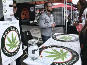 FILE - This March 31, 2018 photo shows a booth advertising a delivery service for cannabis at the Four Twenty Games in Santa Monica, Calif. California is moving a step closer to allowing marijuana deliveries in communities that have banned retail sales. Regulators on Friday, Oct. 19, 2018, announced preliminary approval of the proposed rule over objections from cities and police chiefs who say the policy will lead to crime.