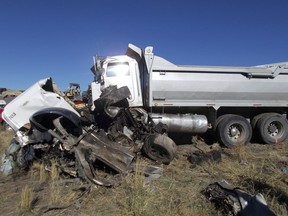 This Friday, Oct. 19, 2018 photo provided by the Utah Highway Patrol shows the scene of a head-on collision of a dump truck and a pickup on a state highway near Heber, Utah. State troopers say the dump truck crossed a highway median and collided with the pickup truck traveling in the opposite direction, killing all six men in the pickup in an accident authorities suspect may was caused by alcohol and prescription drugs. The Utah Highway Patrol said Saturday its officers found prescription pills and open containers of alcohol inside the dump truck. (Utah Highway Patrol via AP)