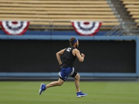 Los Angeles Dodgers starting pitcher Clayton Kershaw warms up on the field Wednesday, Oct. 3, 2018, in Los Angeles, ahead of Thursday's Game 1 of the baseball team's National League Division Series against the Atlanta Braves.
