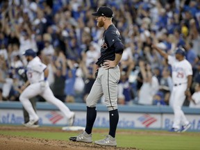 Los Angeles Dodgers' Max Muncy, left, rounds the bases after a three-run home run as Atlanta Braves starting pitcher Mike Foltynewicz waits during the second inning of Game 1 of a baseball National League Division Series on Thursday, Oct. 4, 2018, in Los Angeles.