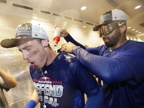 Los Angeles Dodgers' Matt Kemp, left, pours beer on Cody Bellinger while celebrating in the clubhouse after the team's 5-2 win against the Colorado Rockies in a tiebreaker baseball game, Monday, Oct. 1, 2018, in Los Angeles.