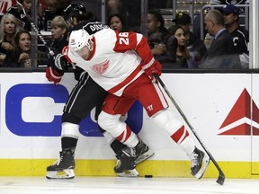 Detroit Red Wings' Thomas Vanek, right, pushes Los Angeles Kings' Drew Doughty against the boards during the first period of an NHL hockey game Sunday, Oct. 7, 2018, in Los Angeles.