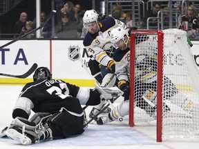 Buffalo Sabres' Jason Pominville (29) hits the puck for a goal against Los Angeles Kings goaltender Jonathan Quick as teammate Jack Eichel watches during the first period of an NHL hockey game Saturday, Oct. 20, 2018, in Los Angeles.