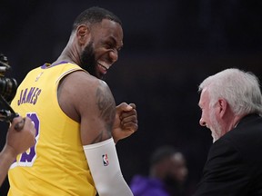 Los Angeles Lakers forward LeBron James, left, greets San Antonio Spurs head coach Gregg Popovich prior to an NBA basketball game Monday, Oct. 22, 2018, in Los Angeles.