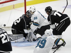 San Jose Sharks' Kevin Labanc (62) scores the game-winning goal past Los Angeles Kings goaltender Jonathan Quick, left, during overtime of an NHL hockey game Friday, Oct. 5, 2018, in Los Angeles. San Jose won 3-2.
