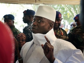 FILE - In this Thursday, Dec. 1, 2016 file photo, Gambia's President Yahya Jammeh shows his inked finger before voting in Banjul, Gambia. Gambia has launched a truth, reconciliation and reparations commission, launched Monday Oct. 15, 2018, to lay bare abuses committed under the 22-year rule of former leader Yahya Jammeh, with President Adama Barrow declaring the country's "dark days" are over.