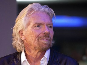 FILE - In this Dec. 10, 2013 file photo, British billionaire Richard Branson visits a Zumba Step dance class at Virgin installations in Madrid, Spain. On Friday, Oct. 12, 2018 Branson announced he has frozen business links with Saudi Arabia amid reports that journalist Jamal Khashoggi may have been murdered at the Saudi consulate in Istanbul.