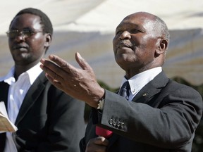 FILE - In this Thursday, Jan. 10, 2008 file photo, President of the Kenyan National Olympic Committee and International Olympic Committee executive member, Kipchoge Keino, right, delivers a speech near the town of Eldoret, Kenya. Running great Kip Keino has handed himself over to police and is under arrest following allegations he and six other Kenyan sports and government officials embezzled and misappropriated more than $545,000 set aside for their team at the 2016 Rio de Janeiro Olympics. Keino, former sports minister Hassan Wario and two other former sports ministry officials surrendered to police Thursday and are due in court Friday to plead to charges of corruption and abuse of office.