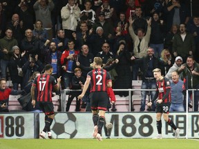 Bournemouth's David Brooks, right, celebrates scoring his side's first goal during the British Premier League soccer match between Bournemouth and Crystal Palace, at the Vitality Stadium in Bournemouth, England, Monday, Oct. 1, 2018.