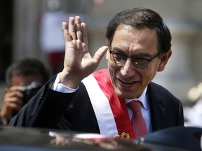 FILE - In tis March 23, 2018 file photo, Peru's newly-sworn in President Martin Vizcarra waves as he makes his way to the House of Pizarro, the presidential residence and workplace, also known as Government Palace, in Lima, Peru. Vizcarra, a soft-spoken engineer stepped into Peru's presidency earlier this year after his predecessor resigned amid scandal.