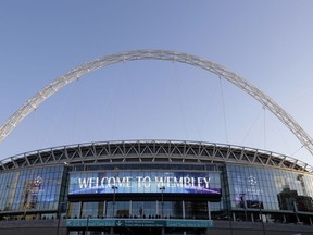 A view of the exterior of Wembley Stadium in London, Wednesday, Oct. 3, 2018. Britain is looking to host up to 60 major sporting events over the next 15 years, including soccer's World Cup, to assert global influence and secure trade deals after Brexit. Building on the successful of the 2012 Olympics in London and the English Premier League, hosting major sporting events is now embraced as a key instrument of soft power by British Prime Minister Thresa May's government. The UK Sport list of sporting events being targeted was revealed hours after May's speech to her Conservative Party conference, with the centerpiece the 2030 World Cup.