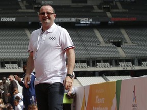 FILE - In this Monday May 15, 2017 file photo, International Olympic Committee Evaluation Commission Chair Patrick Baumann smiles as he visits the Stade de France stadium, in Saint-Denis, outside Paris. Patrick Baumann, the CEO-like secretary general of basketball's world governing body who was seen as a potential IOC president, has died at the Youth Olympics it was announced on Sunday, Oct, 14 2018. He was 51. The International Basketball Federation says Baumann "unexpectedly succumbed to a heart attack" in Buenos Aires.