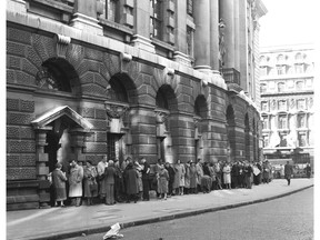FILE - In this Oct. 27, 1960 file photo, a queue forms outside The Old Bailey Central Criminal Court, in London, for admission to the public gallery where the "Lady Chatterley's Lover" case is resuming. A paperback copy of "Lady Chatterley's Lover" used by the judge in the U.K. obscenity trial of the novel's publisher has sold at auction for 56,250 pounds ($72,000), more than three times its pre-sale estimate. The tattered Penguin paperback _ along with a damask bag designed to stop photographers snapping the judge with the scandalous tome _ sold to an anonymous bidder at Sotheby's in London on Tuesday, Oct. 30, 2018. (AP Photo, File)