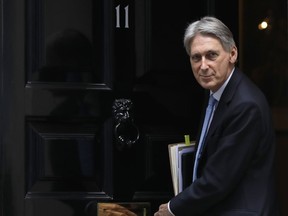 FILE - In this Wednesday, March 21, 2018 file photo, Britain's Chancellor Philip Hammond leaves 11 Downing Street to attend the weekly session of Prime Ministers Questions in Parliament in London. Britain's Treasury chief says the country would need a new economic strategy if it leaves the European Union without a deal. Speaking on Sunday, Oct. 29, the day before he delivers his budget in the House of Commons, Philip Hammond told Sky News his plan is based on the idea there will be a deal. If there isn't one, he says Britain "would need to look at a different strategy and, frankly, we'd need to have a new budget that set out a different strategy for the future."