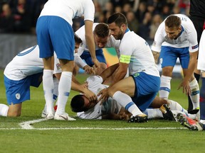 Slovenia's Luka Krajnc lies on the pitch injured during the UEFA Nations League soccer match between Norway and Slovenia at Ullevaal Stadium, Norway, Saturday Oct. 13, 2018.