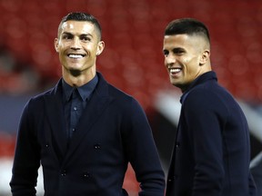 Juventus' Cristiano Ronaldo, left, during the walkaround at Old Trafford, Manchester, England, Monday, Oct. 22, 2018. Juventus will play a Champions League soccer match against Manchester United on Tuesday.