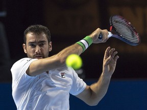 Croatia's Marin Cilic returns a ball to Canada's Denis Shapovalov during their first round match at the Swiss Indoors tennis tournament at the St. Jakobshalle in Basel, Switzerland, on Monday, Oct. 22, 2018.