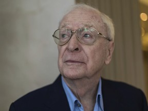 British actor Michael Caine poses for a photograph in London, Thursday, Oct. 11, 2018.  The 85-year-old star reminisces fondly about his life in his book "Blowing the Bloody Doors Off," published Tuesday Oct. 23, 2018, in the United States, which is part memoir and part advice manual for aspiring actors and anyone else nursing an elusive dream of success.
