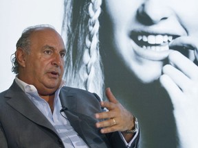 FILE - In this file photo dated Wednesday, June 5, 2013, Philip Green speaks during an interview at his new Topshop store in Hong Kong.  British politician Peter Hain has used British Parliament's free-speech guarantee to name the prominent businessman Philip Green, who according to Hain, is facing employee allegations of sexual harassment and racial abuse and previously secured a court order barring the media from revealing his identity.