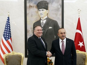 U.S. Secretary of State Mike Pompeo shakes hands with Turkish Foreign Minister Mevlut Cavusoglu before their talks in Ankara, Turkey, October 17, 2018.   On Wednesday a pro-government Turkish newspaper published a report made from what they described as an audio recording of Saudi writer and journalist Jamal Khashoggi's alleged torture and slaying at the Saudi Consulate in Istanbul.