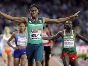 FILE - In this Aug. 13, 2017, file photo, South Africa's Caster Semenya celebrates after winning the gold in the final of the Women's 800m during the World Athletics Championships in London. The governing body of track and field will not apply rules to limit natural testosterone levels in female runners until the Court of Arbitration for Sport concludes a case involving Olympic champion Caster Semenya.