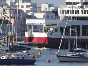 The Red Funnel car ferry, Red Falcon, which earlier collided with several small boats due to bad weather, leaves East Cowes on the Isle of Wight bound for Southampton, southern England, Sunday Oct. 21, 2018.  The ferry collided with several yachts and ran aground while trying to berth at a harbor on the Isle of Wight off southern England in dense fog early Sunday. No injuries were reported.