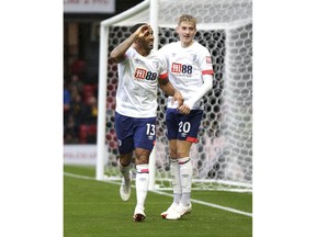Bournemouth's Callum Wilson, left, celebrates scoring against Watford during the English Premier League soccer match at Vicarage Road, Watford, England, Saturday Oct. 6, 2018.
