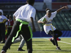 Local schoolchildren take part in activities during an NFL Flag football event before a training session at Allianz Park in London, Friday Oct. 19, 2018. The Los Angeles Chargers are preparing for an NFL football game against the Tennessee Titans at London's Wembley stadium on Sunday.