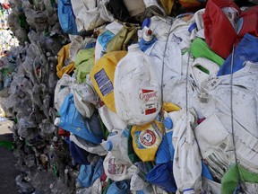 In this Thursday, Sept. 6, 2018, photo, bundled plastic goods, which were separated from paper and metal recyclable materials, are stacked and awaiting processing at EL Harvey & Sons, a waste and recycling company, in Westborough, Mass. Recycling programs across the United States are shutting down or scaling back because of a global market crisis blamed on contamination at the curbside bin.