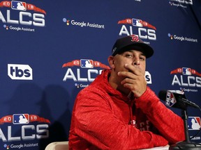 Boston Red Sox manager Alex Cora listens to a question during a news conference at a baseball workout, Thursday, Oct. 11, 2018, in Boston. The Red Sox face the Houston Astros in Game 1 of baseball's American League Championship Series on Saturday at Fenway Park in Boston.