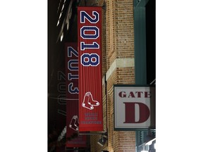 The 2018 World Series baseball championship banner hangs outside Fenway Park in Boston, Monday, Oct. 29, 2018. The Boston Red Sox won the series against the Los Angeles Dodgers on Sunday in Los Angeles.