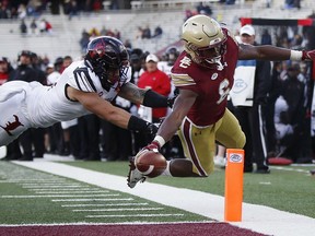 Boston College wide receiver Jeff Smith (6) reaches over the goal line to score a touchdown against Louisville safety London Iakopo during the second half of an NCAA college football game in Boston, Saturday, Oct. 13, 2018.
