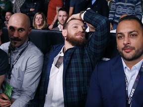 UFC champion Conor McGregor sits ringside before the boxing match between Demetrius Andrade and Walter Kautondokwa in Boston, Saturday, Oct. 20, 2018.