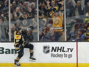 Boston Bruins right wing David Pastrnak (88) reacts after scoring during the first period of an NHL hockey game against the Detroit Red Wings, Saturday, Oct. 13, 2018, in Boston.