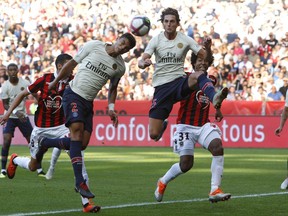 Paris Saint Germain's Thiago Silva, left, and Paris Saint Germain's Adrien Rabiot, challenges for the ball with Nice's Dante Santos, during the League One soccer match between Nice and Paris Saint-Germain at the Allianz Riviera stadium in Nice, southern France, Saturday, Sept. 29, 2018.