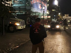 In this Monday, Oct. 22, 2018 photo, a member of the Fenway Park security team stands outside the ballpark in preparation for Tuesday's Game 1 of the World Series baseball game between the Red Sox and Los Angeles Dodgers in Boston. Excitement builds in Boston as baseball's World Series gets underway, so are security measures as authorities race to keep fans safe.