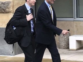 Dennis Boyle, left, and Blerina Jasari, lawyers for Dawn Bennett, walk outside the federal courthouse, Thursday, Oct. 11, 2018, in Greenbelt, Md. Authorities and a government witness say that Bennett cast paranormal spells and spent nearly three-quarters of a million dollars on prayers in a desperate attempt to avoid charges that she orchestrated a multimillion-dollar Ponzi scheme.