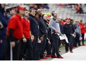 Maryland interim head coach Matt Canada, at right in gray, stands on the sideline in the first half of an NCAA college football game against Illinois, Saturday, Oct. 27, 2018, in College Park, Md.