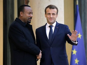 Ethiopian Prime Minister Ably Ahmed, left, is welcomed by French President Emmanuel Macron at the Elysee Palace in Paris, France, Monday, Oct. 29, 2018.