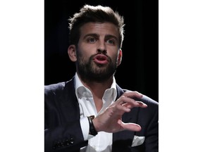 FC Barcelona soccer player and founder of investment group Kosmos, Gerard Pique delivers his speech during the presentation of the city of Madrid as hosts of the new Davis Cup for the next two years in Madrid, Spain, Wednesday, Oct. 17, 2018.