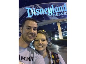 This Oct. 17, 2018 photo provided by Clark Ensminger, shows him with his wife Heather Ensminger at Disneyland in Anaheim, Calif. The couple visited four Disney parks in the Orlando, Fla., area and two Disney parks in the Los Angeles area, with a cross-country flight in between, all within 20 hours and two time-zone changes.