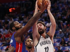 Brooklyn Nets forward Joe Harris (12) is defended by Detroit Pistons center Andre Drummond during the first half of an NBA basketball game, Wednesday, Oct. 17, 2018, in Detroit.