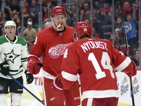 Detroit Red Wings right wing Anthony Mantha, front left, is congratulated by right wing Gustav Nyquist (14), of Sweden, after scoring a goal against the Dallas Stars in the second period of an NHL hockey game in Detroit, Sunday, Oct. 28, 2018.