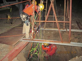 A rescue team lowering themselves into an old abandoned mine shaft to rescue a man who fell into the shaft on Monday, Oct. 15, 2018, near Aguila, Ariz.